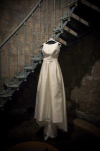wedding dress hanging on a stairway